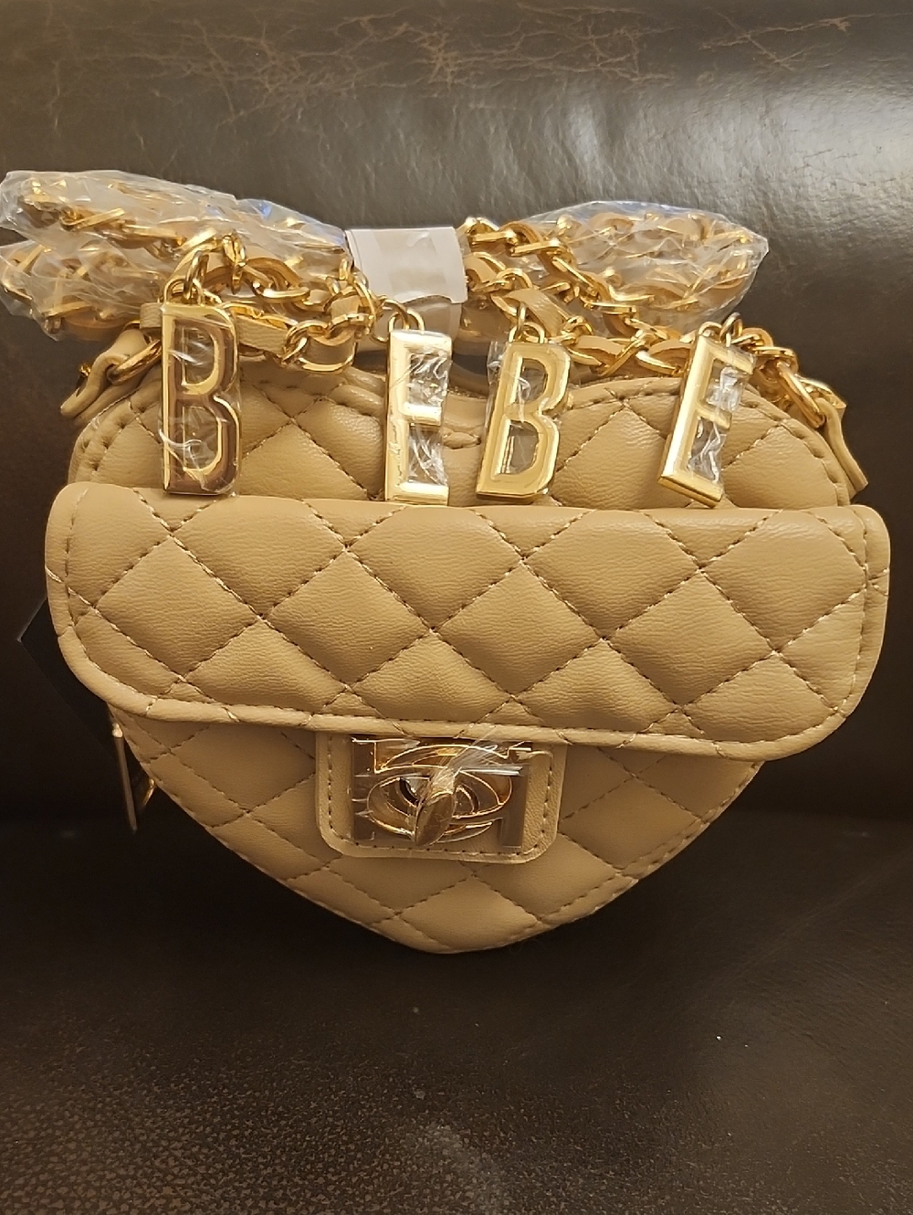 bebe Solana Quilted Mini Heart Crossbody Bag in Beige with Gold Hardware